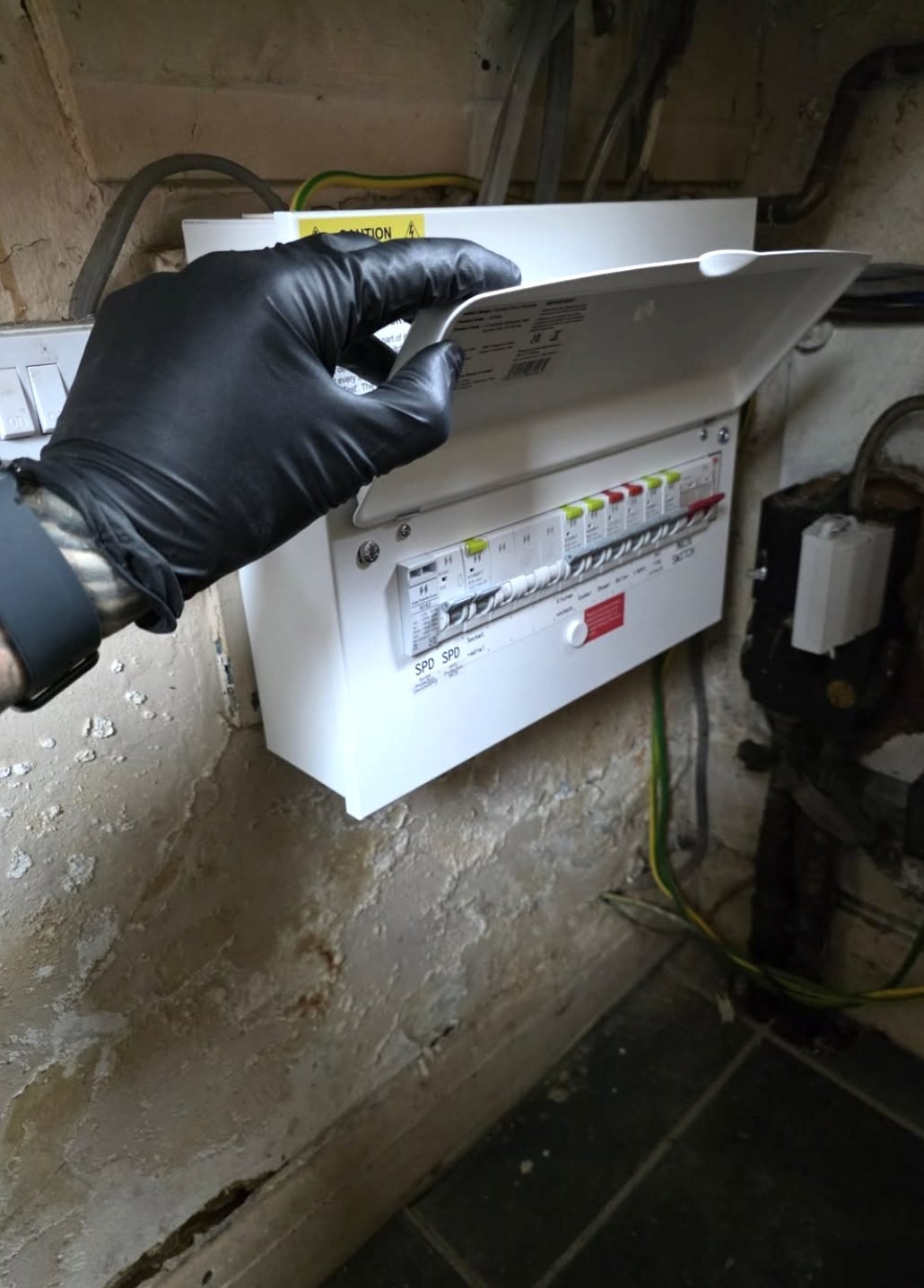 Electrician opening a newly fitted consumer unit during testing