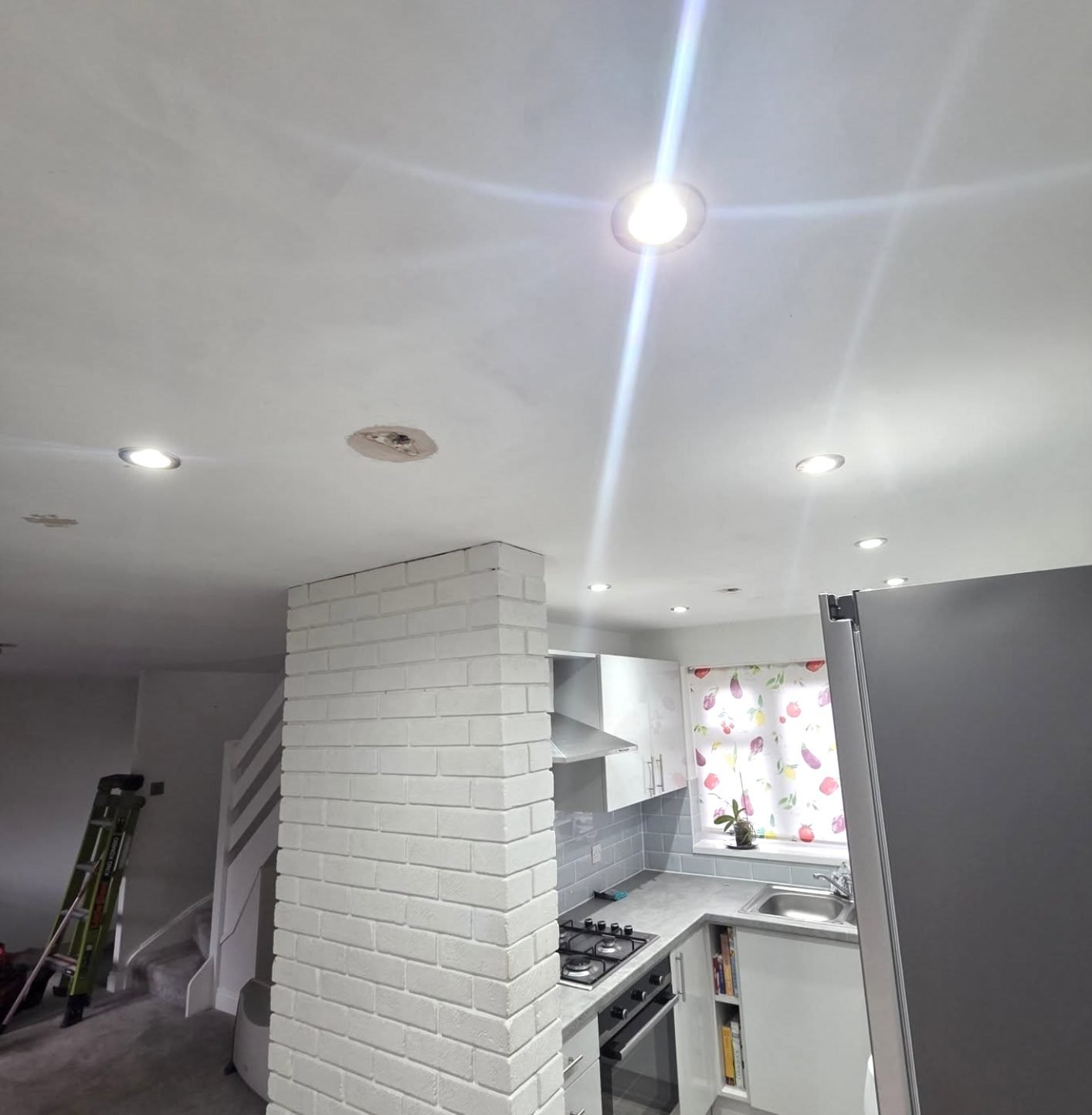 Open plan kitchen ceiling with newly installed recessed downlights
